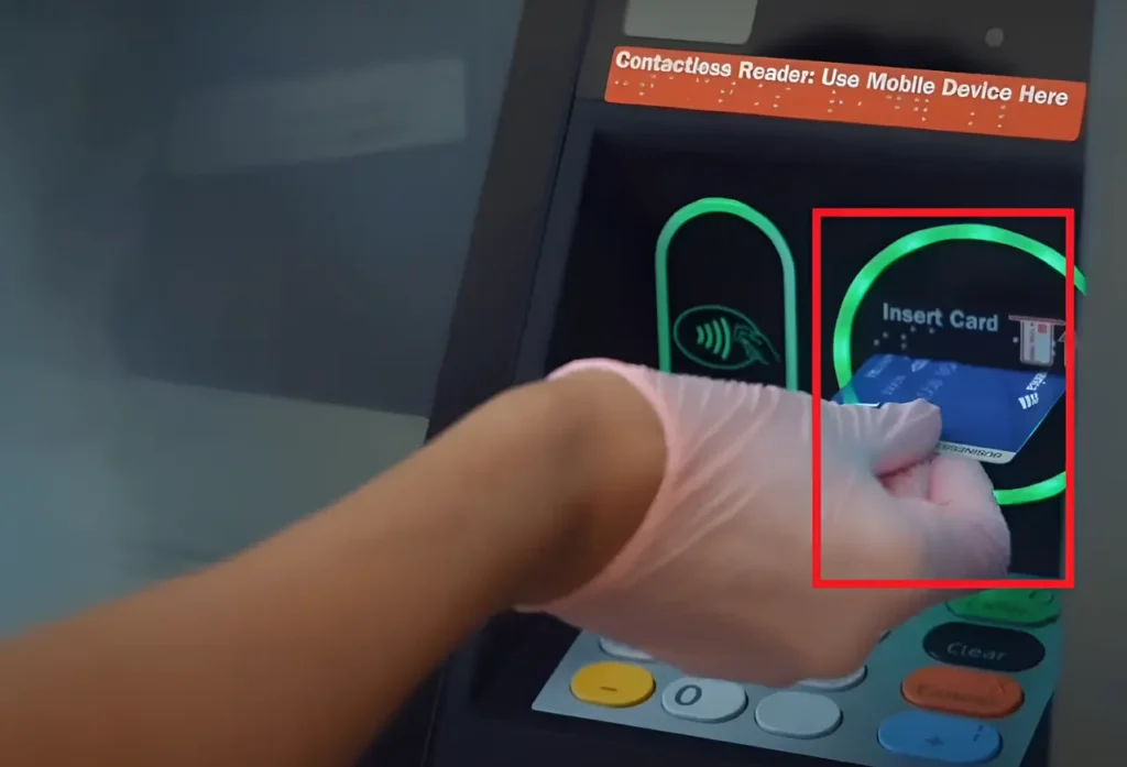 Inserting card into the card reader slot in ATM 